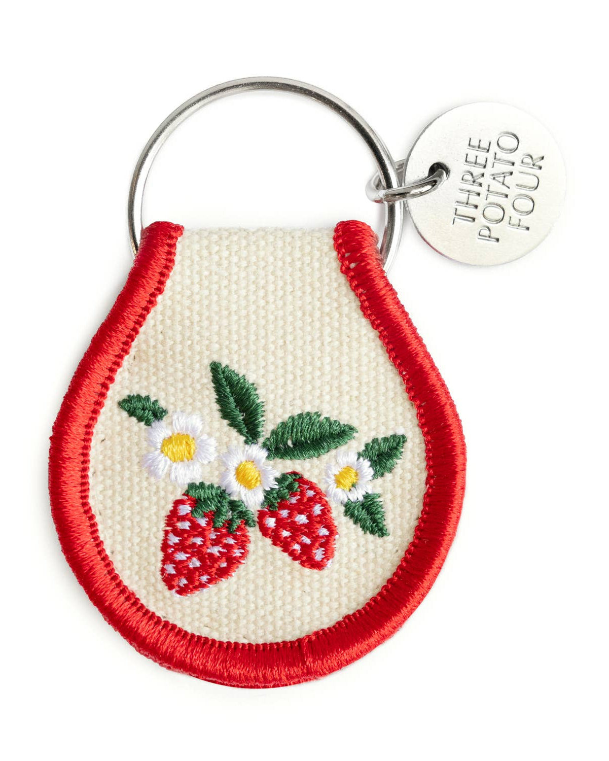 Keychain with embroidered strawberries and daisies on a white background