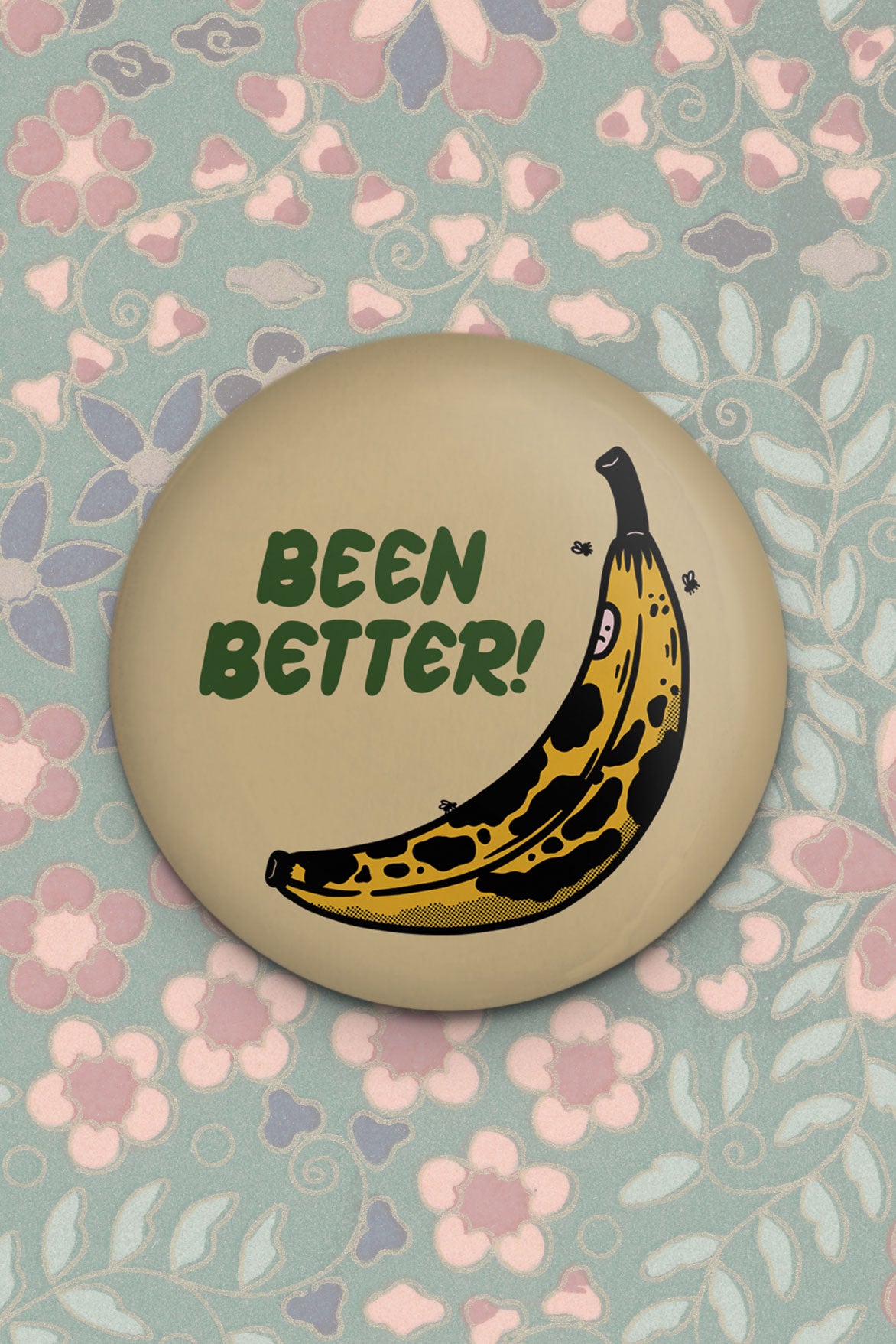 Round magnet with image of a bruised banana and the phrase "been better!"
