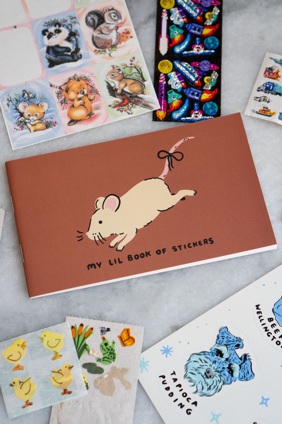 Small sticker album with a cute mouse and "my lil book of stickers" printed on the cover
