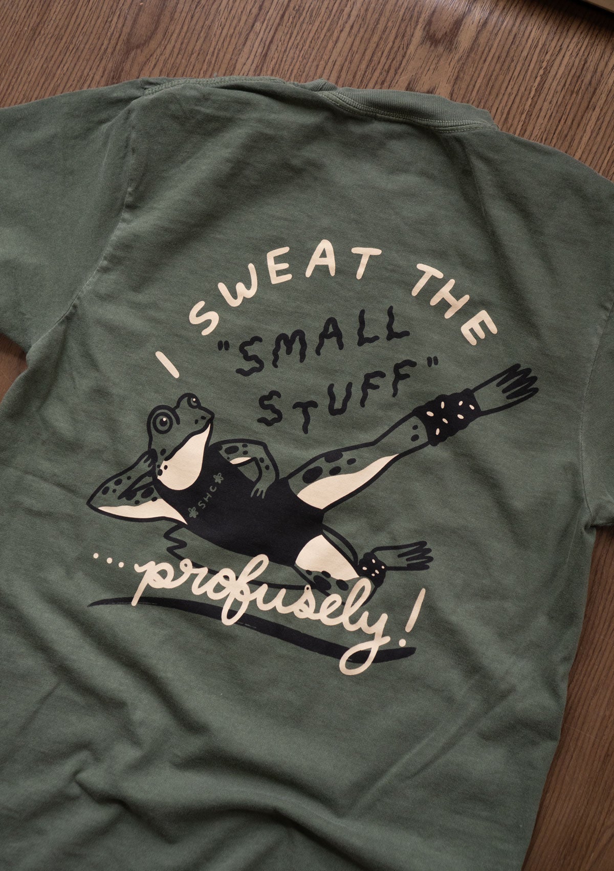 T-shirt print of a frog in '80s workout gear and the phrase "I sweat the small stuff - profusely!"