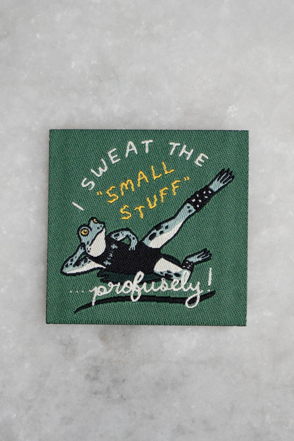Patch with woven image of a frog in workout gear and the phrase "I sweat the small stuff - profusely!"