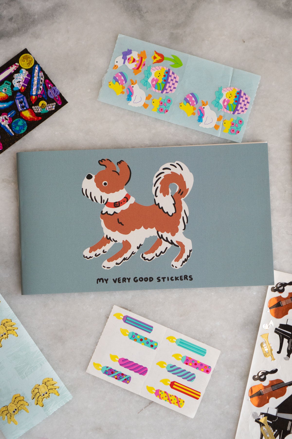 Sticker album with a dog and "my very good stickers" printed on the cover